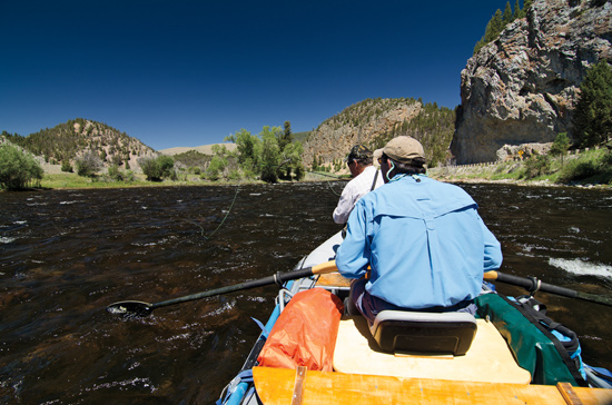 Fly anglers in a raft floating down the Big Hole River