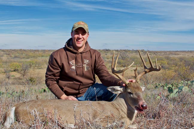 hunter posing with whitetail buck