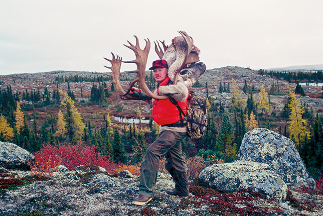 Craig Boddington carrying out caribou antlers