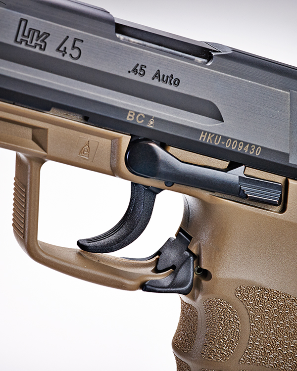 The HK45's magazine release is a lever on the trigger guard rather tha...