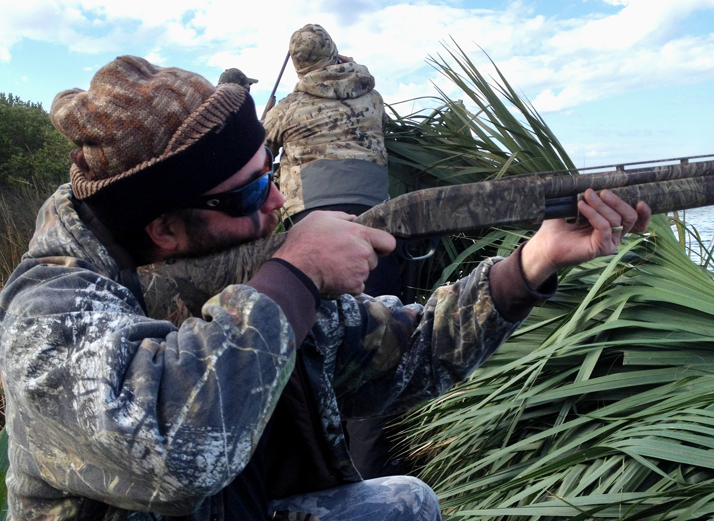 close up of hunter in camo with gun